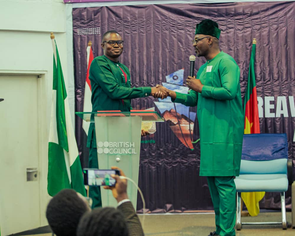 Eric Coffie, President of ILEE receiving a congratulatory message and award from Olawale Owoyomi, the Executive Director of WALEC