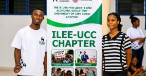 Two ILEE-UCC student members stand beside the chapter banner at the University of Cape Coast, highlighting campus leadership and liberty education initiatives.