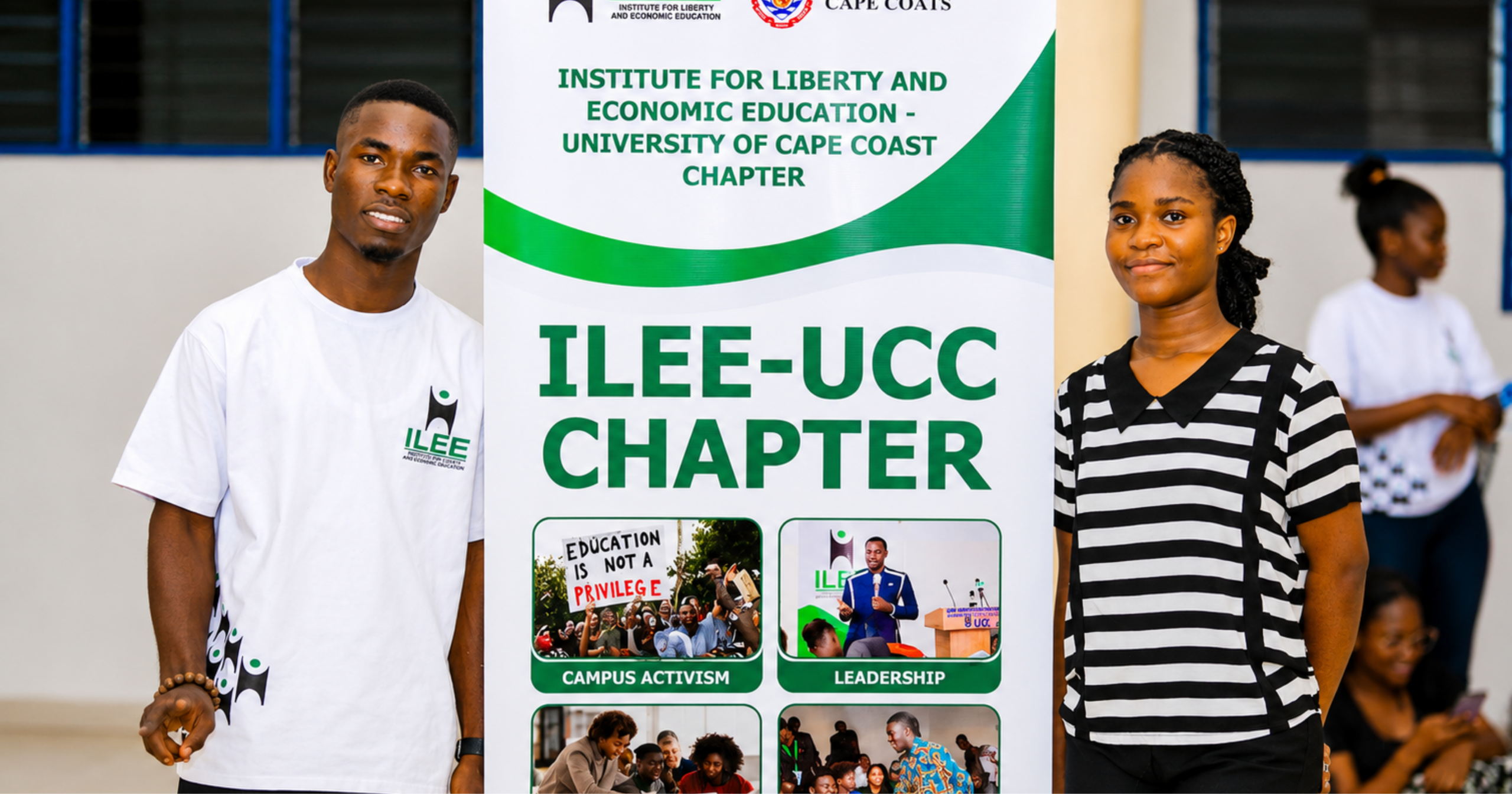 Two ILEE-UCC student members stand beside the chapter banner at the University of Cape Coast, highlighting campus leadership and liberty education initiatives.