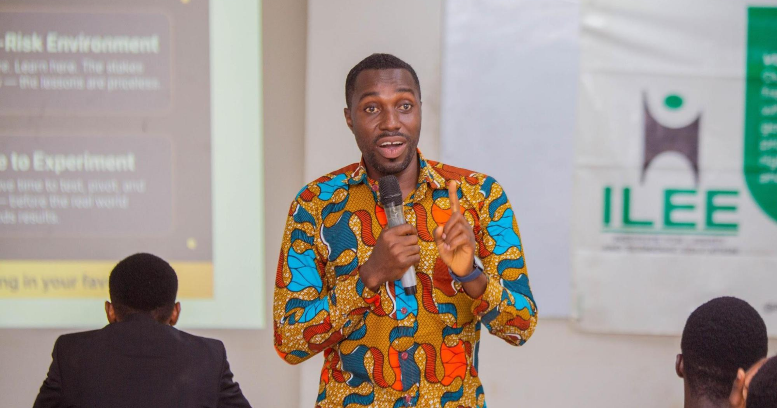 A speaker delivers a presentation to students during an Institute for Liberty and Economic Education (ILEE) event, engaging the audience on entrepreneurship and economic development.
