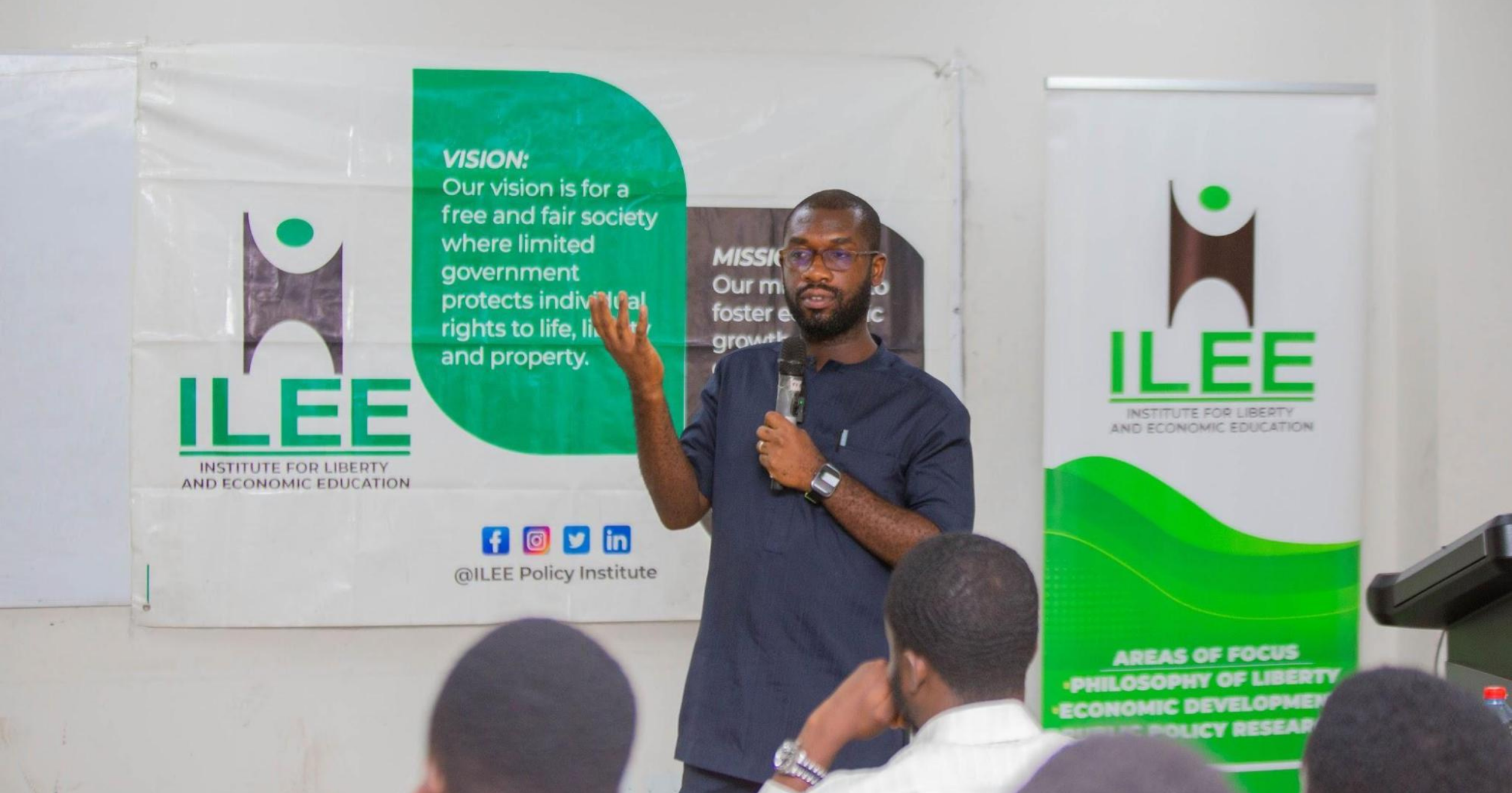 A guest speaker delivers a presentation during an Institute for Liberty and Economic Education (ILEE) event while addressing participants on economic education and public policy.