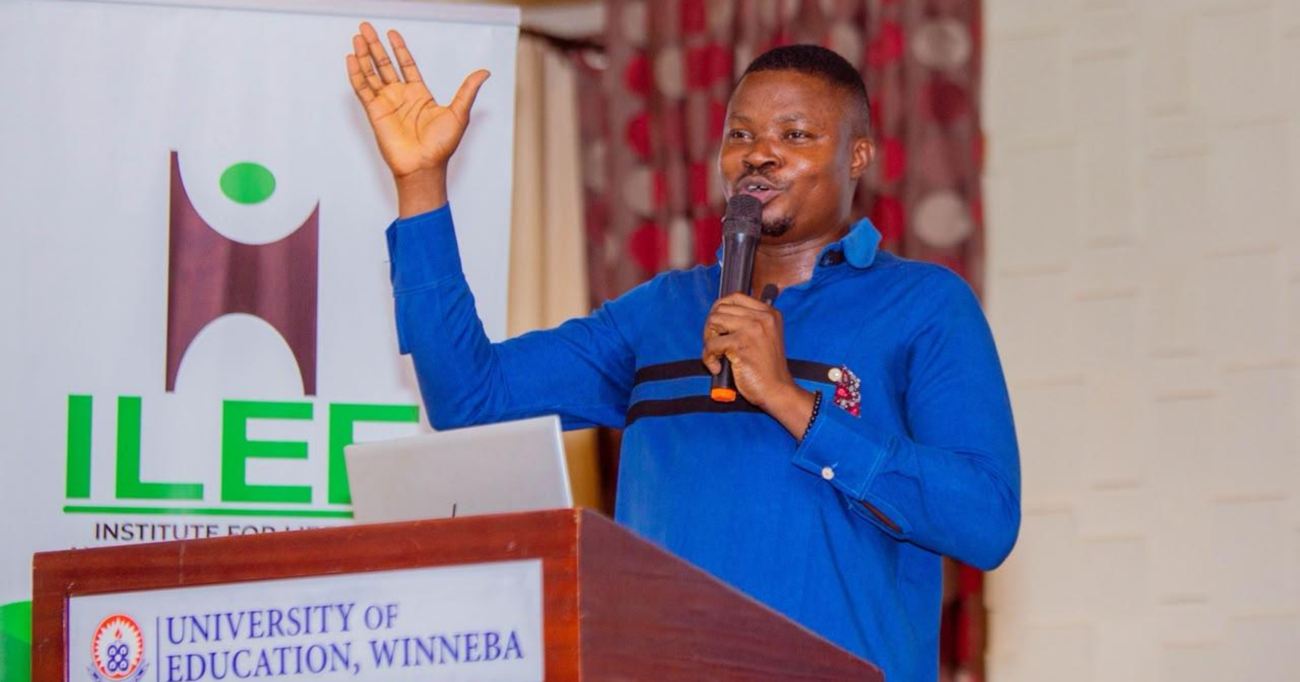 Dr. Paul Appiah-Konadu speaking at the podium during the Liberty & AI Summit 2026 at the University of Education, Winneba, with an ILEE banner in the background.