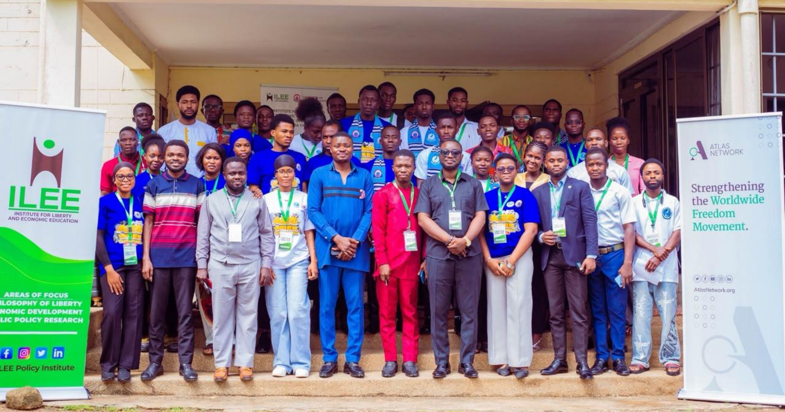 Group photo of participants, speakers, and organizers at the Liberty & AI Summit 2026 held at the University of Education, Winneba, standing in front of the venue with ILEE and Atlas Network banners.
